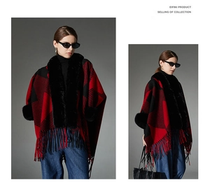 Detail view of red and black checkered poncho with faux fur collar and tassel edges