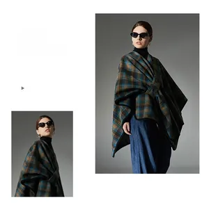 Detail of classic blue and brown plaid shawl cape in thick fabric on a model