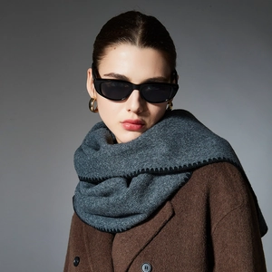 Deep grey winter knit scarf with handmade black stitching and brown tweed coat for couples