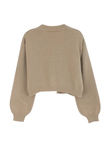 Detail of oatmeal knit cardigan showing ribbed cuffs and soft embroidered texture