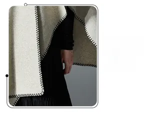 Close-up of light gray double-sided wool shawl with decorative black whipstitch edge detail