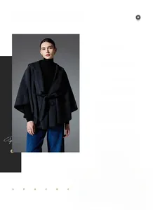 Detail of dark grey hooded wool cape with waist belt closure for women in winter