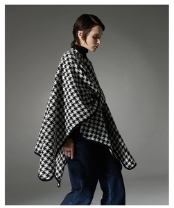 Close-up of the black and white houndstooth knit fabric texture and premium black edging