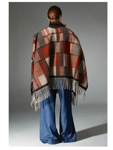 Rear view of a camel wool plaid shawl featuring elegant fringe and classic orange patterns