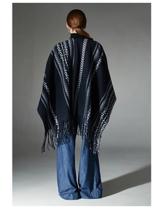 Close-up of ethnic style dark blue knit shawl featuring geometric jacquard and long tassels