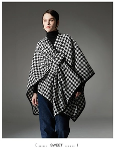 Classic black and white houndstooth shawl wrap with buckle closure and woven texture