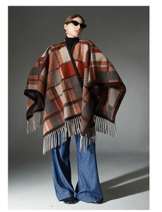 Detail of camel wool-textured plaid shawl with orange fringe edges for autumn style