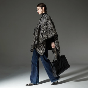 Classic zebra print poncho shawl with black trim, heavy knit wrap for autumn and winter