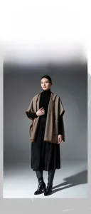 Detail of herringbone hooded shawl with leather trim and large functional pockets