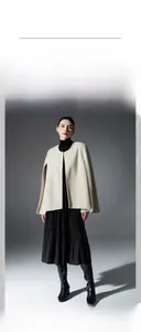 Close-up of beige double-faced wool shawl showing premium texture and structured fit