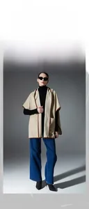 Detail view of beige plaid hooded shawl with high-quality brown leather piping and soft texture
