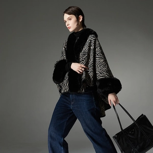Fashionable zebra print knit poncho with luxurious black faux fur collar and trim