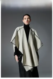 Detail of grey wool blend shawl with black whipstitch edges and minimalist stylish design