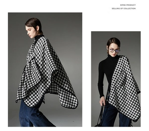 Detailed close-up of a houndstooth cape featuring high-quality thick black trim and buckle