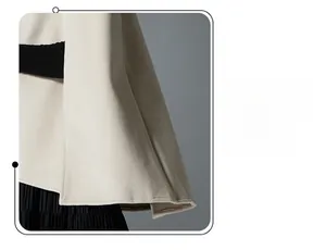 Detail of the elegant double-sided wool shawl showing refined hem work and drape
