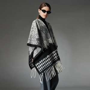 Chic black and white houndstooth wool cape with tassels for stylish autumn outfits
