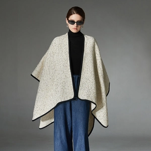 Elegant off-white tweed poncho with gold thread and black trim for women