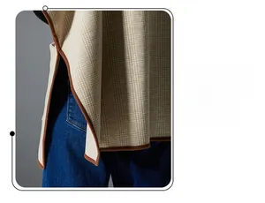 Detail of beige plaid shawl showing high-quality edge binding and woven fabric texture