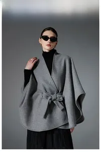 Detail of grey double-sided wool shawl cape with a belted waist and rounded edges