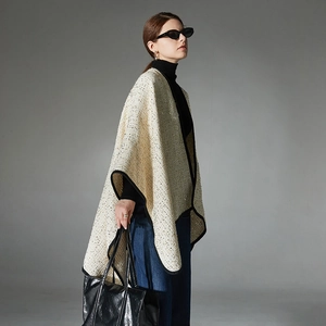 Elegant beige tweed women's shawl cape with gold silk threads and black trim detail