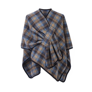 Women's plaid poncho wrap featuring crisscross design and contrast black trim edges