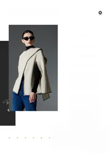 Detail view of cream knit poncho wrap with black blanket stitch edges and Nordic style