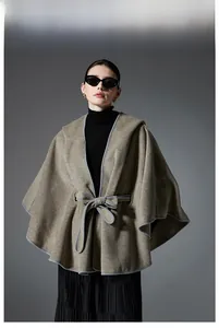 Detail of waist tie and hooded design on a minimalist beige wool blend poncho cape