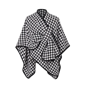Elegant black and white houndstooth knit shawl with buckle and asymmetric hem design