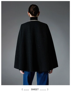 Rear view of women's black tweed cape jacket with metallic threads and draped A-line silhouette