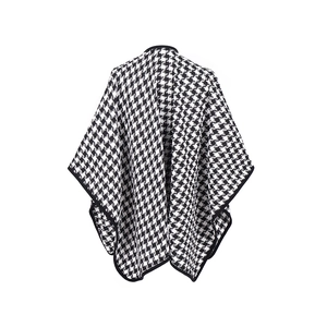 Detail of classic black and white houndstooth knit shawl with elegant black hem