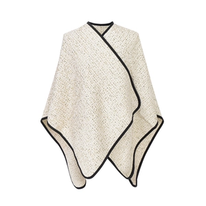 Elegant tweed poncho in cream and gold weave with black trim for autumn and winter