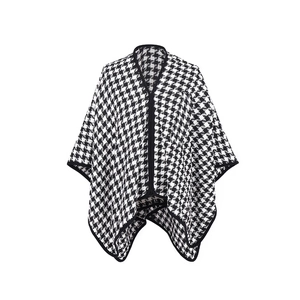 Detail of classic black and white houndstooth knit shawl with fine black edge trim