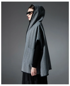 Detail of grey herringbone hooded shawl with black piping for autumn and winter