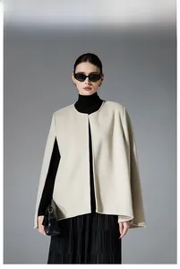 Detail of a minimalist cream-white sleeveless cape jacket made of double-sided wool fabric