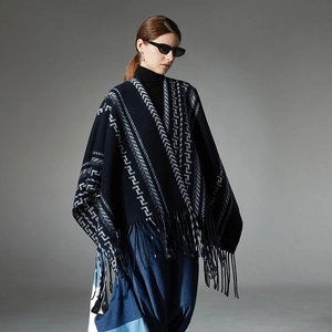 Navy blue geometric jacquard knit poncho with fringe details for autumn and winter