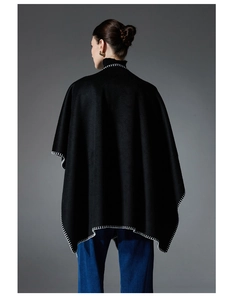 Detailed back view of black wool shawl with white hand-stitched contrast edges and long fit