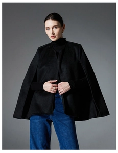 Elegant black sleeveless shawl cape in double-sided wool shown in a full-length fashion pose