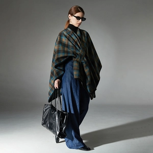 Women's plaid poncho shawl with blue and brown check pattern and black trim