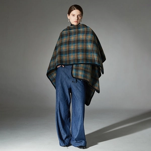 Women plaid wrap shawl poncho in brown blue check pattern over jeans for autumn and winter