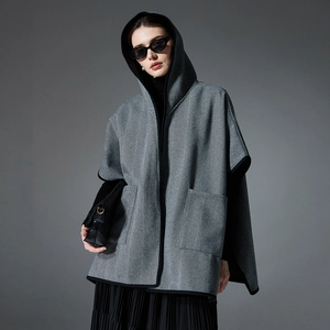 Grey herringbone hooded poncho with black piping and pockets for autumn and winter