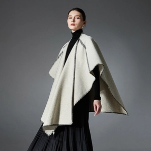 Women's autumn wool blend shawl jacket in oatmeal color with black hand-stitched edges