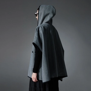 Women's grey hooded poncho cape with classic herringbone pattern and black trim edges