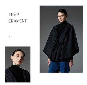 Detail of dark grey wool cape featuring a belted waist and stylish hooded design