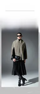 Detailed view of oatmeal wool shawl with contrast white stitching and side arm slits