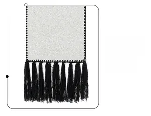Detail of white wool scarf featuring black tassel fringe and reinforced zigzag stitching