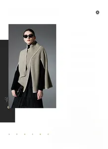 Detail of khaki Nordic knit poncho with white hand-stitched decorative seams and edges