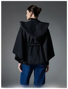 Rear view of dark grey hooded poncho showing the draped silhouette and black piping details