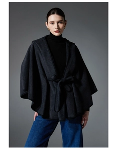 Detail of hooded wool blend cloak featuring elegant waist belt and batwing sleeves