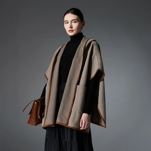 Elegant grey herringbone hooded poncho with faux leather trim and front pockets