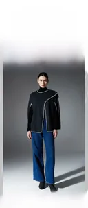 Detail of black double-sided wool shawl with white contrast stitching and modern design